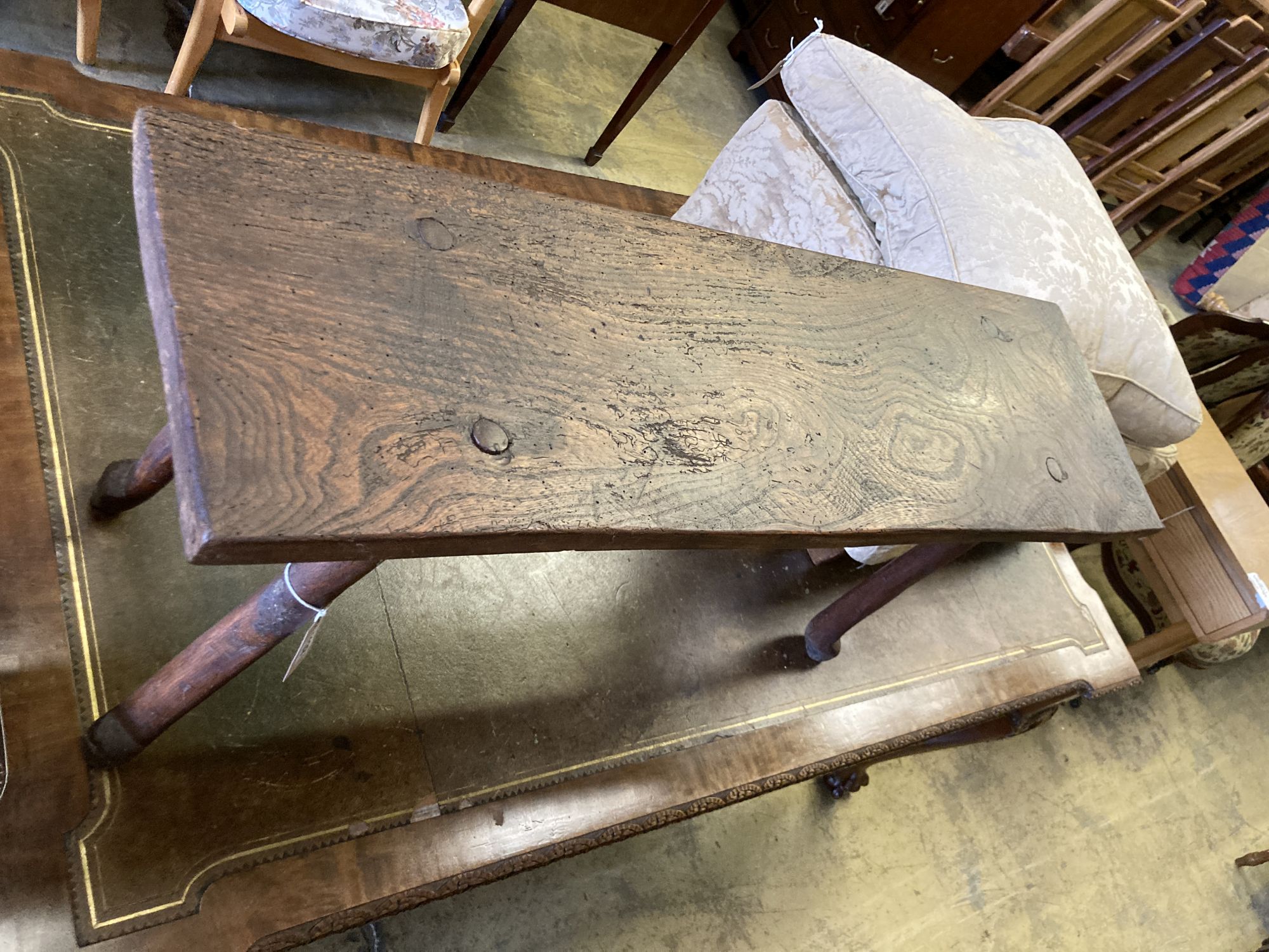 A small 19th century elm bench, on pegged legs, length 101cm, depth 30cm, height 49cm